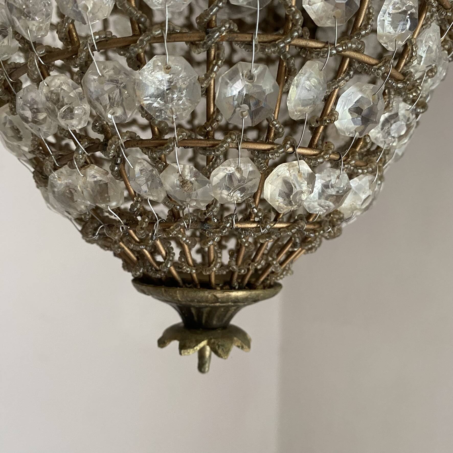 Brass basket chandelier with Louis XVI style pendants.