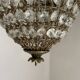 Brass basket chandelier with Louis XVI style pendants.