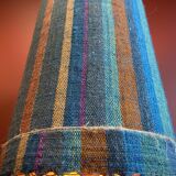 "Stoneware Bottle Lamp" with a multicoloured blue lampshade handwoven in India.