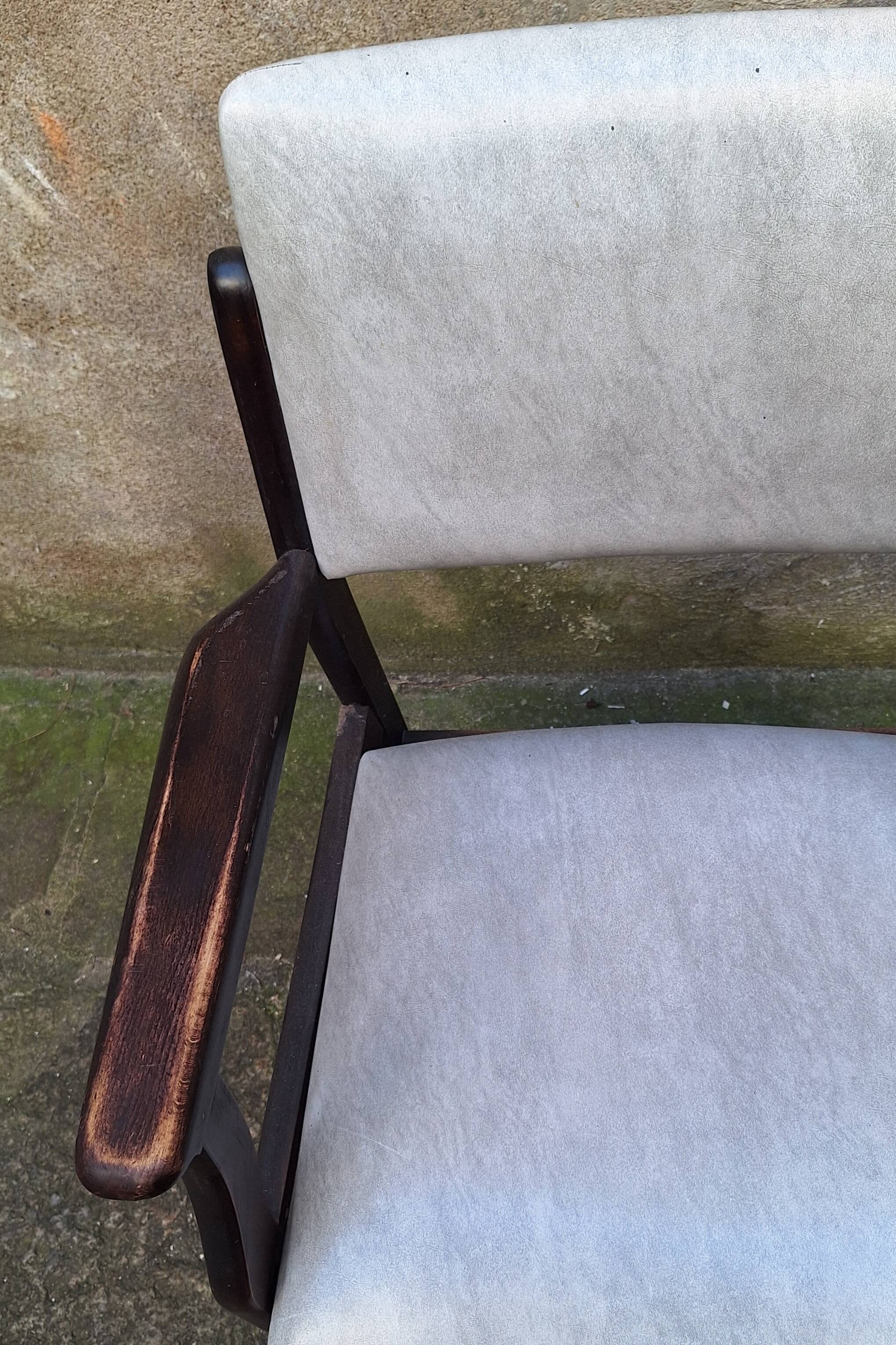 Wooden armchair and faux leather.