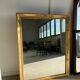 Miroir doré style Restauration à décor de palmettes étirées