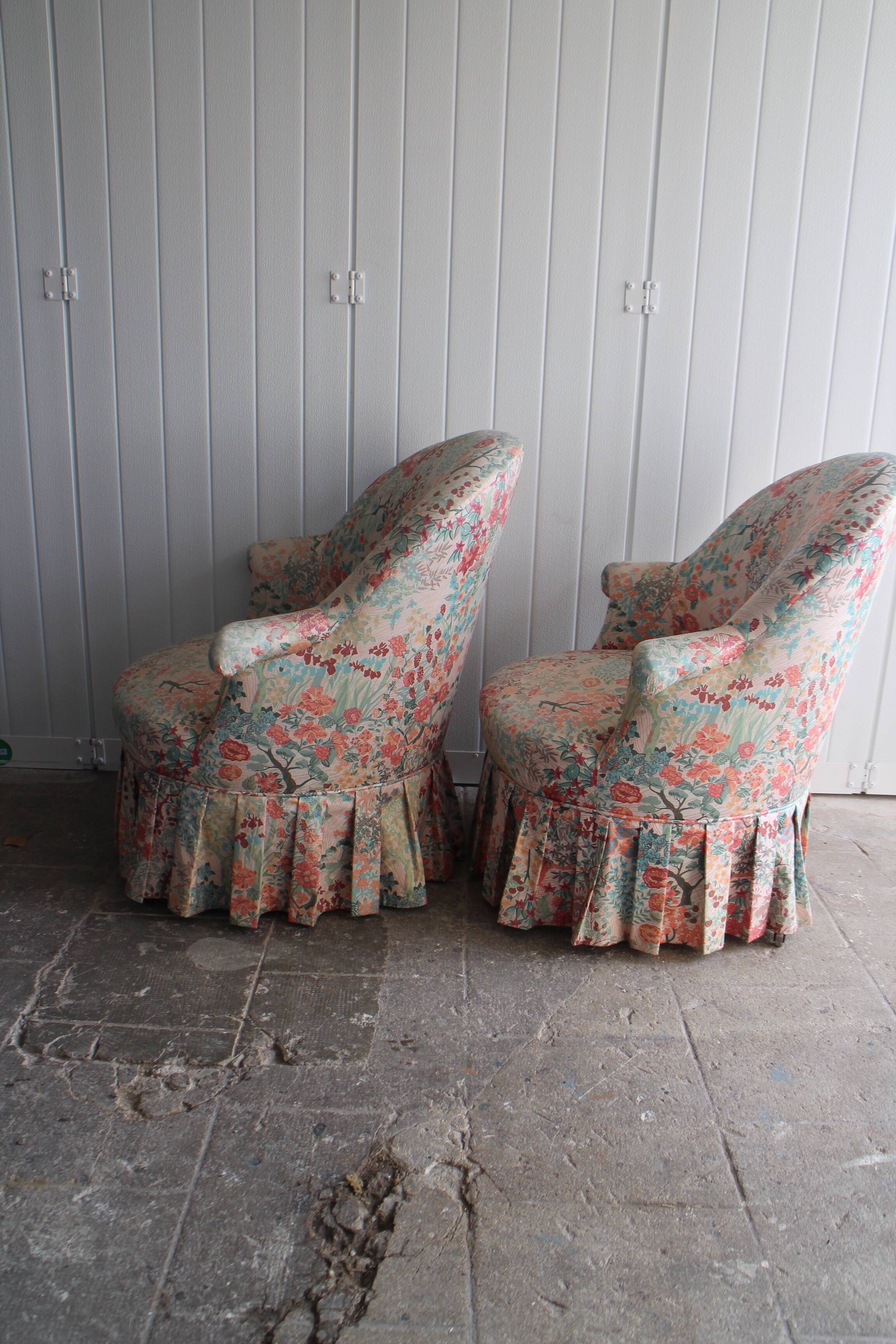 pair of toad armchairs in floral fabric.