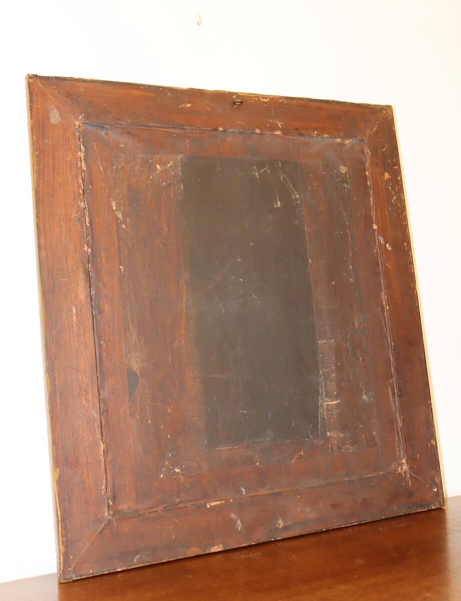 Rectangular mirror in gilded wood with relief decoration of flowers.