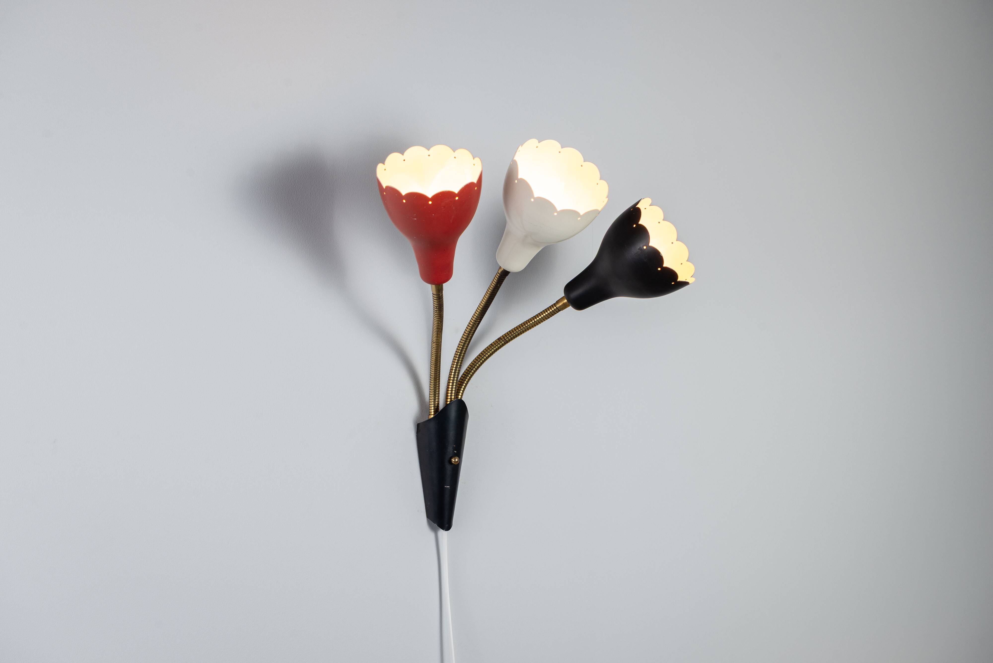 Adjustable wall lamp with three decorated shades in different colours