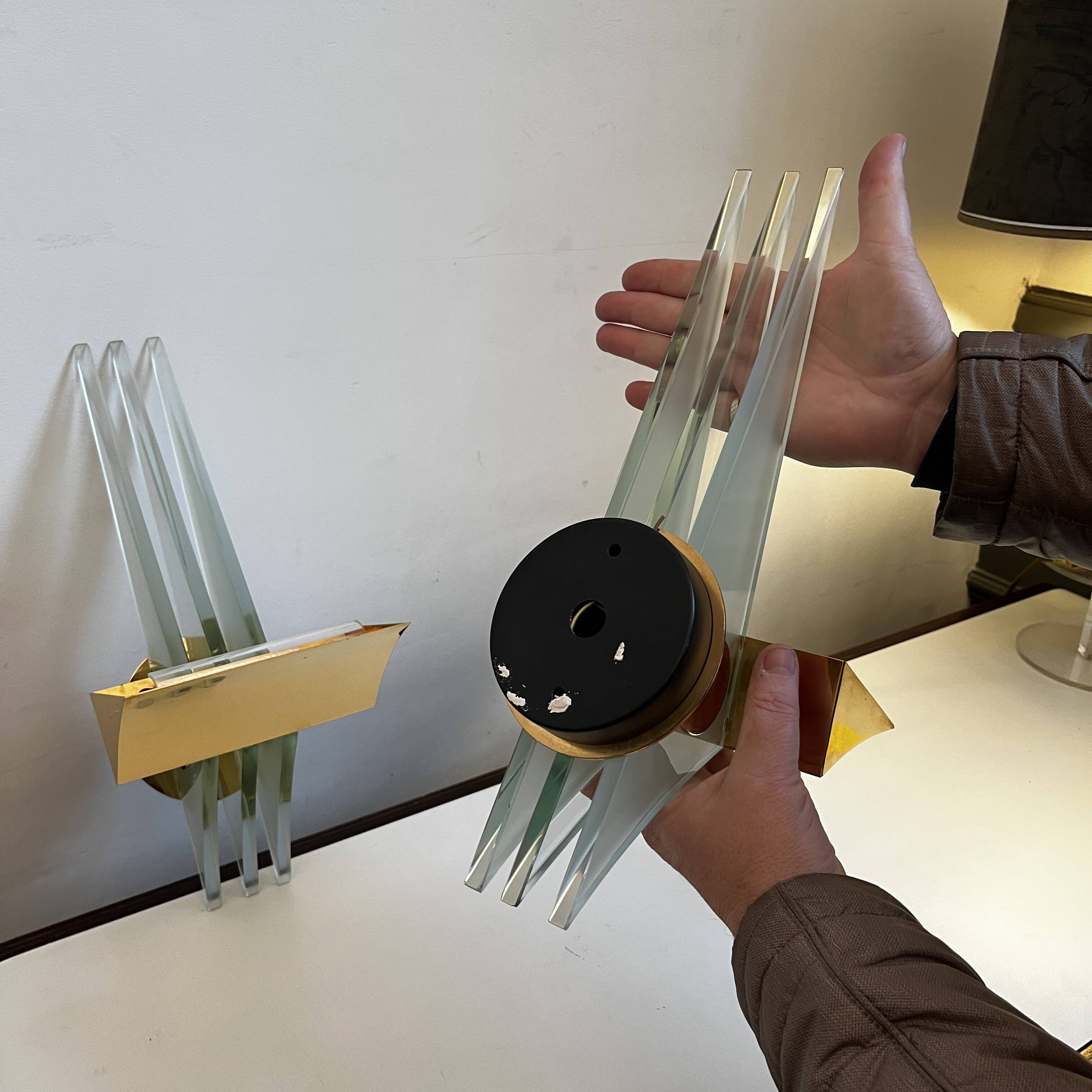 Pair of Hollywood Regency wall lights, bases & reflectors in gilded brass