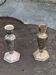 Pair of metal candlesticks, chiseled with a statuette in front, rose pattern in relief, art deco