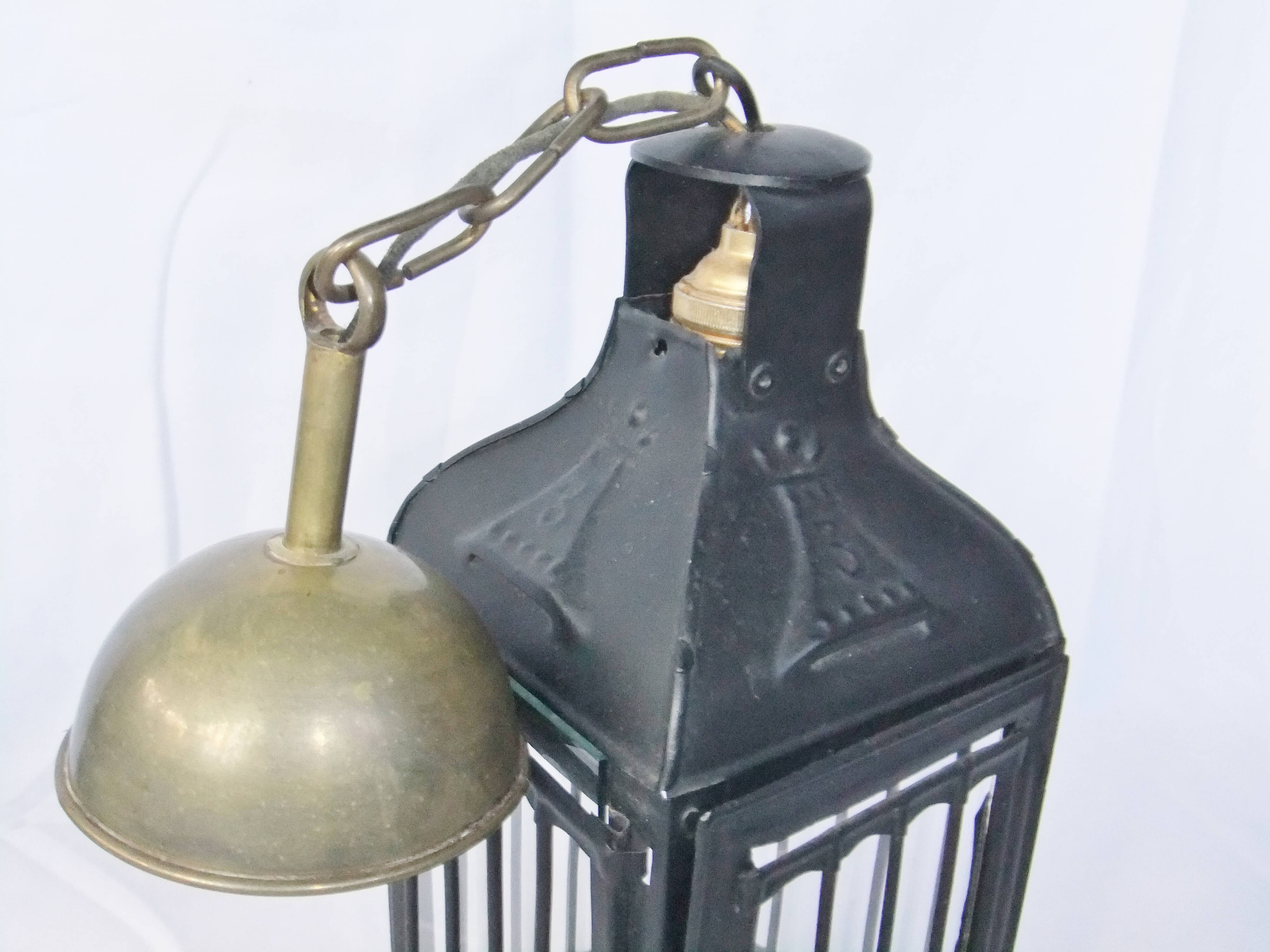 Old chandelier hanging lantern with candle in sheet metal
