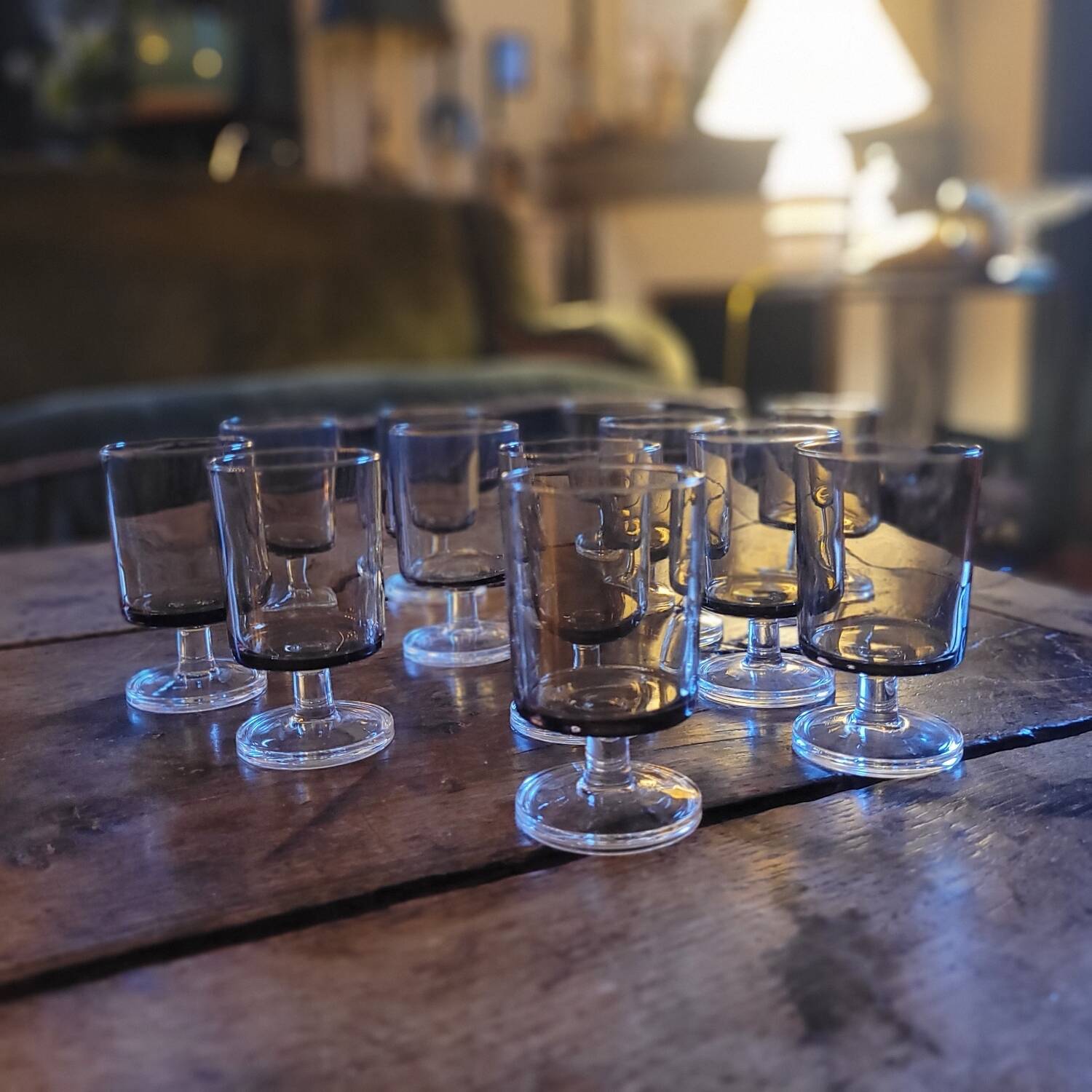 12 smoked glass stemmed glasses from the 70s and 80s.