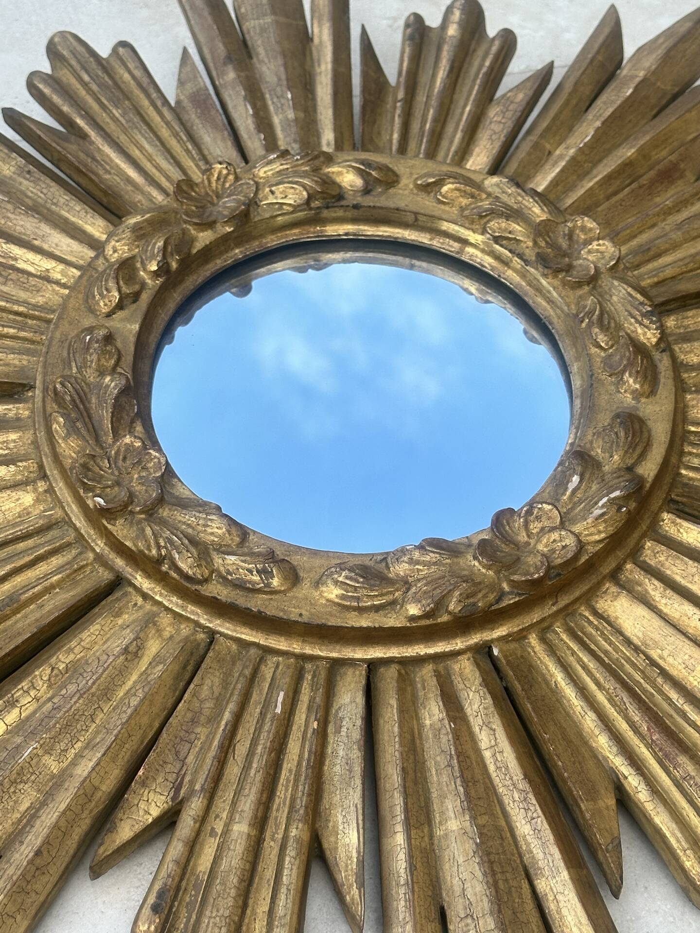Large sun mirror in carved gilded wood.