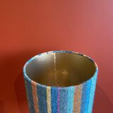 "Stoneware Bottle Lamp" with a multicoloured blue lampshade handwoven in India.