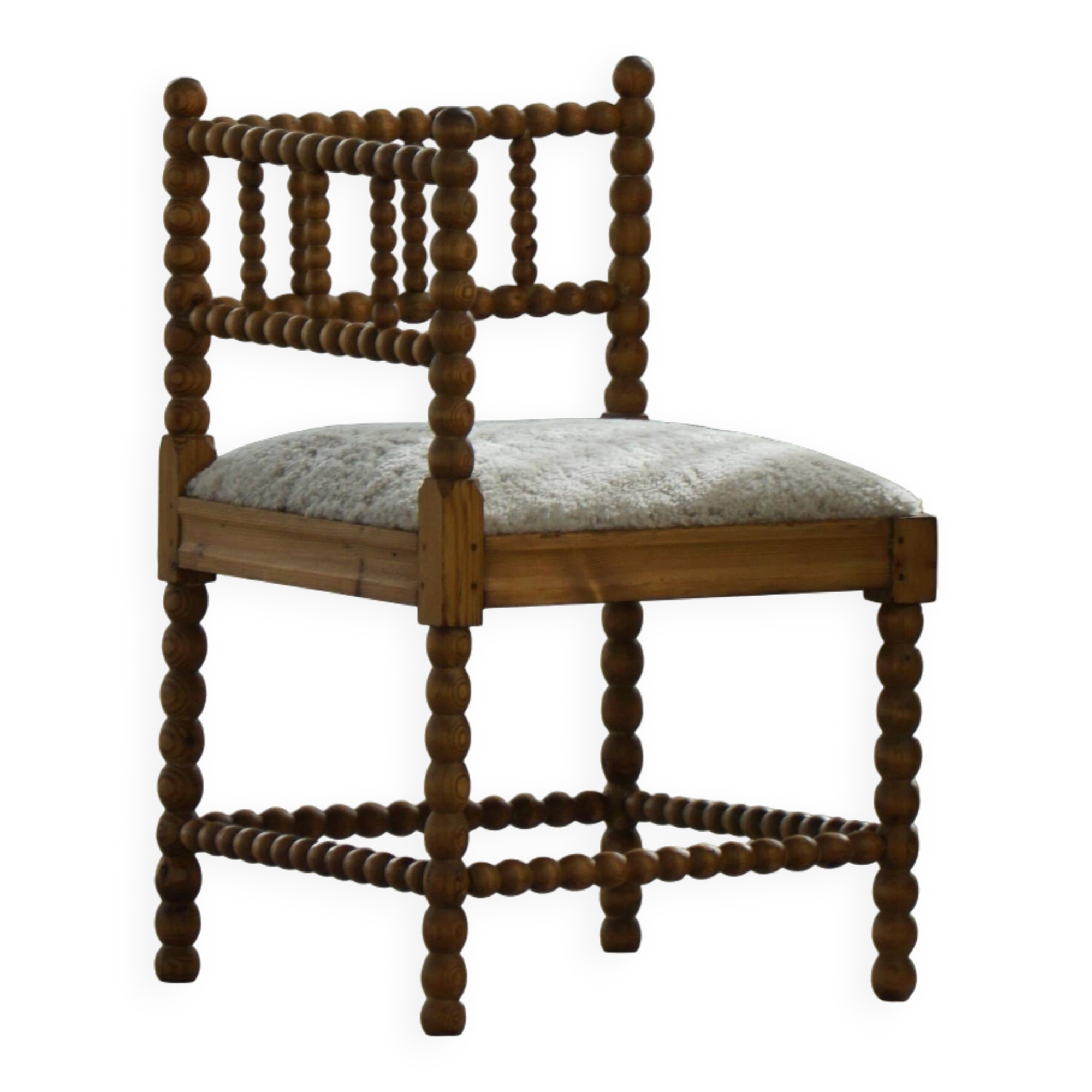 Antique French corner chair handcrafted with lamb's wool, early 20th century.