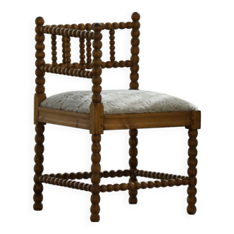 Antique French corner chair handcrafted with lamb's wool, early 20th century.
