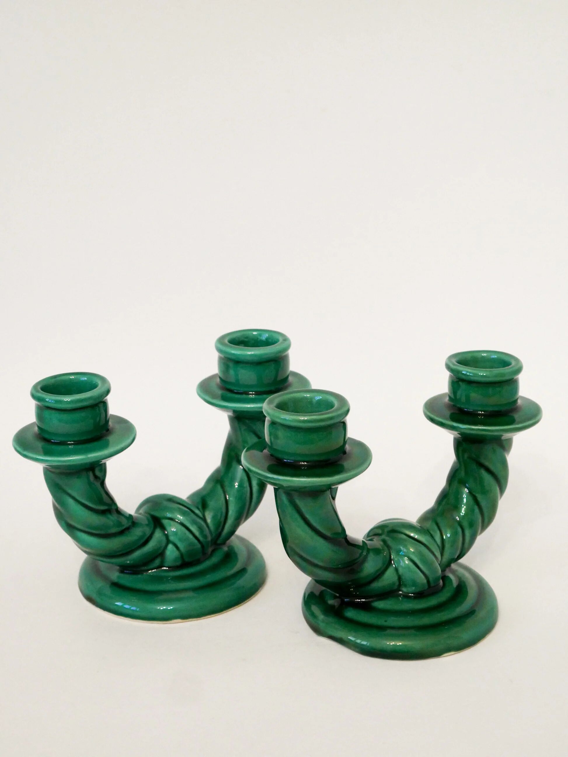 Pair of twisted green ceramic double candlesticks, 1960.
