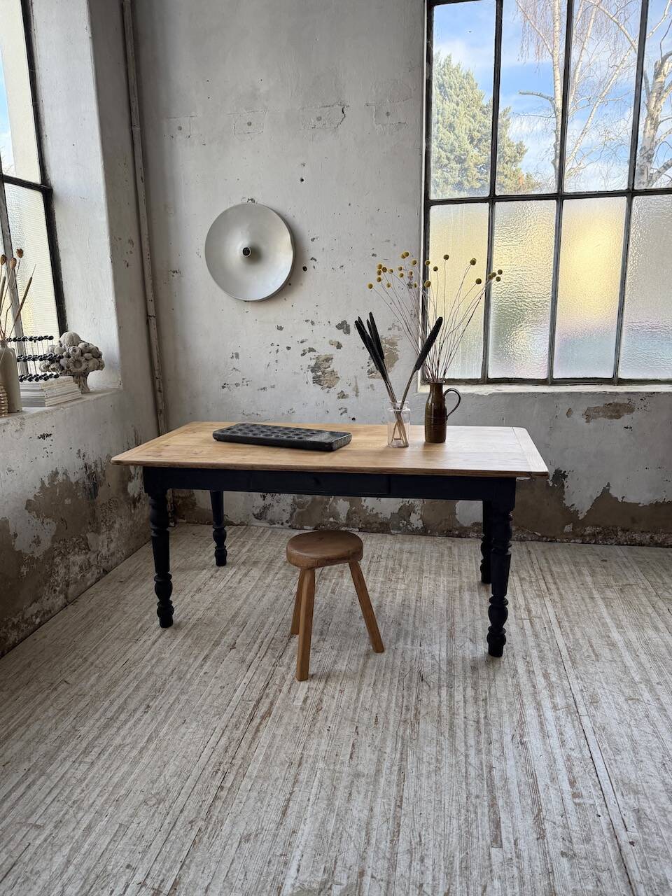 Oak farmhouse table with turned black legs.