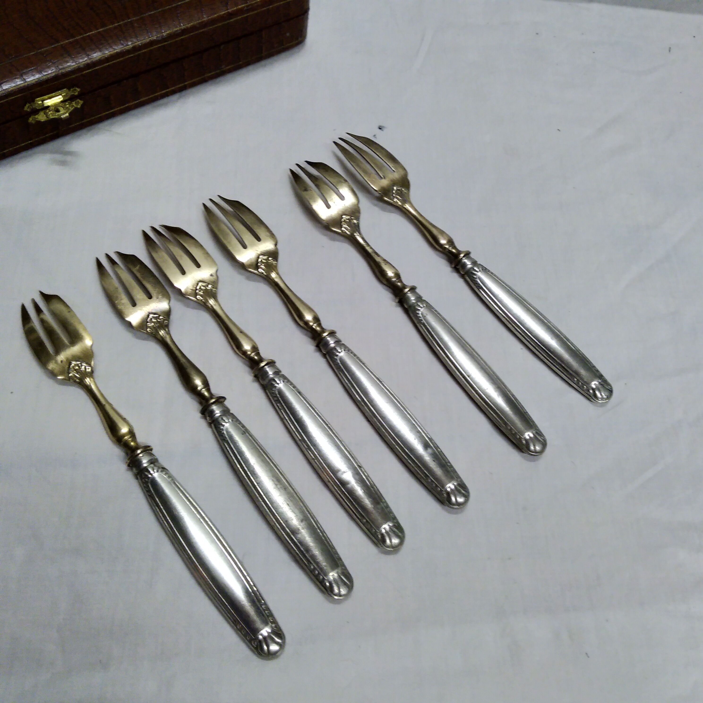 Silver and gold cake fork service