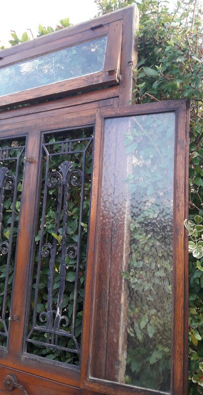 Oak entrance door and its frame and transom, wrought iron gates