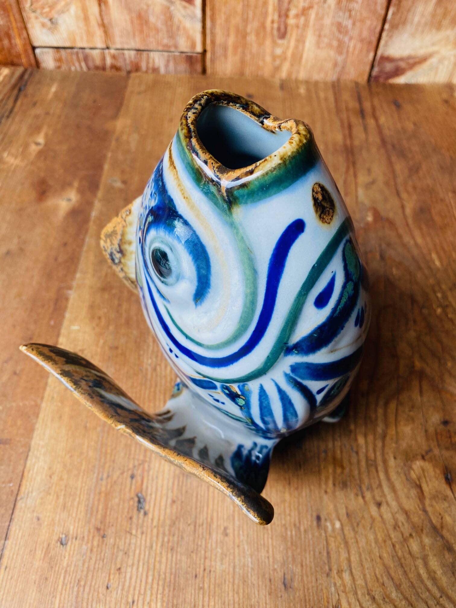 Blue ceramic zoomorphic vase in the shape of a poison.