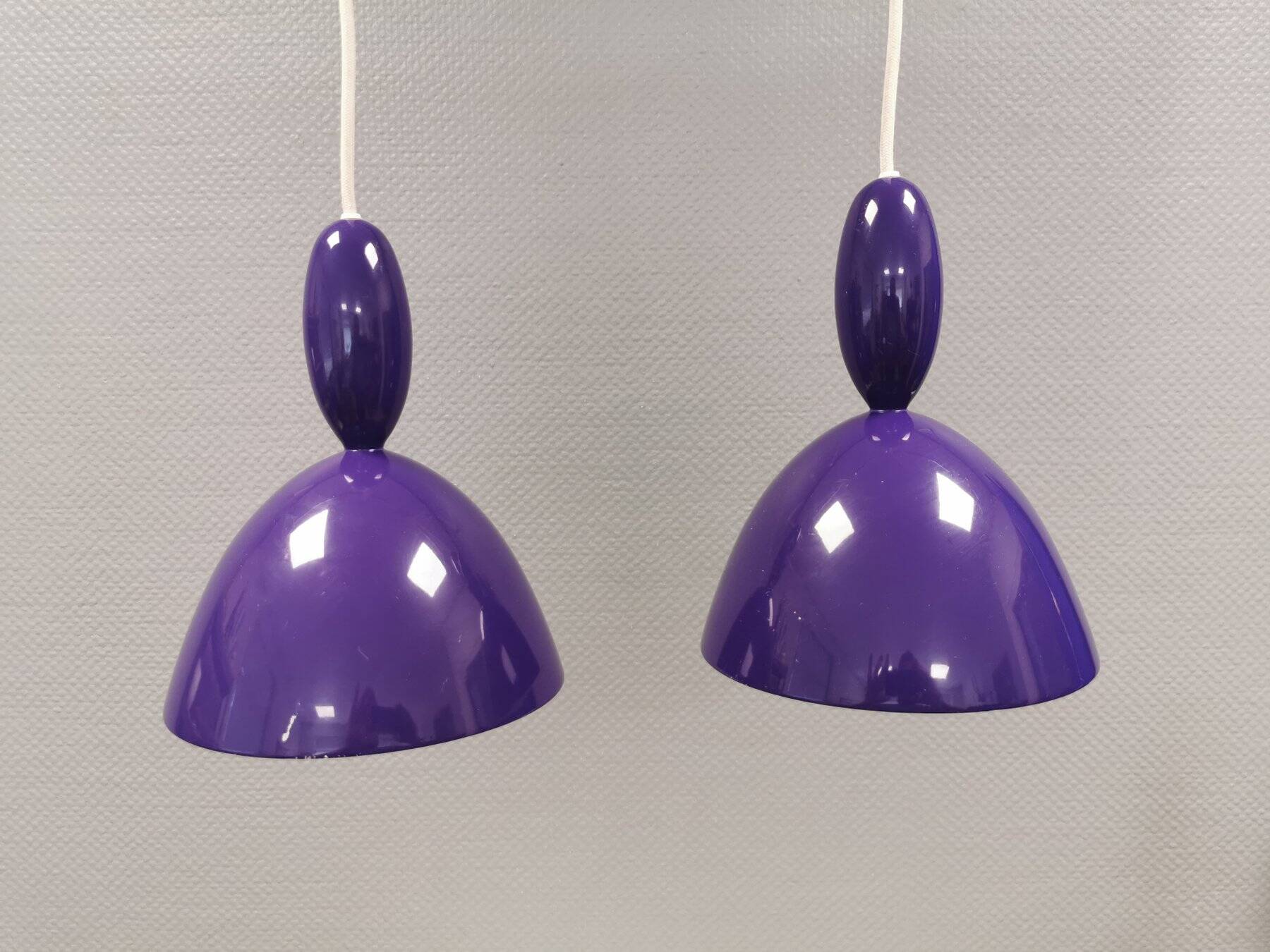 Two purple hanging lamps from Norway Says for Muuto, model Mhy