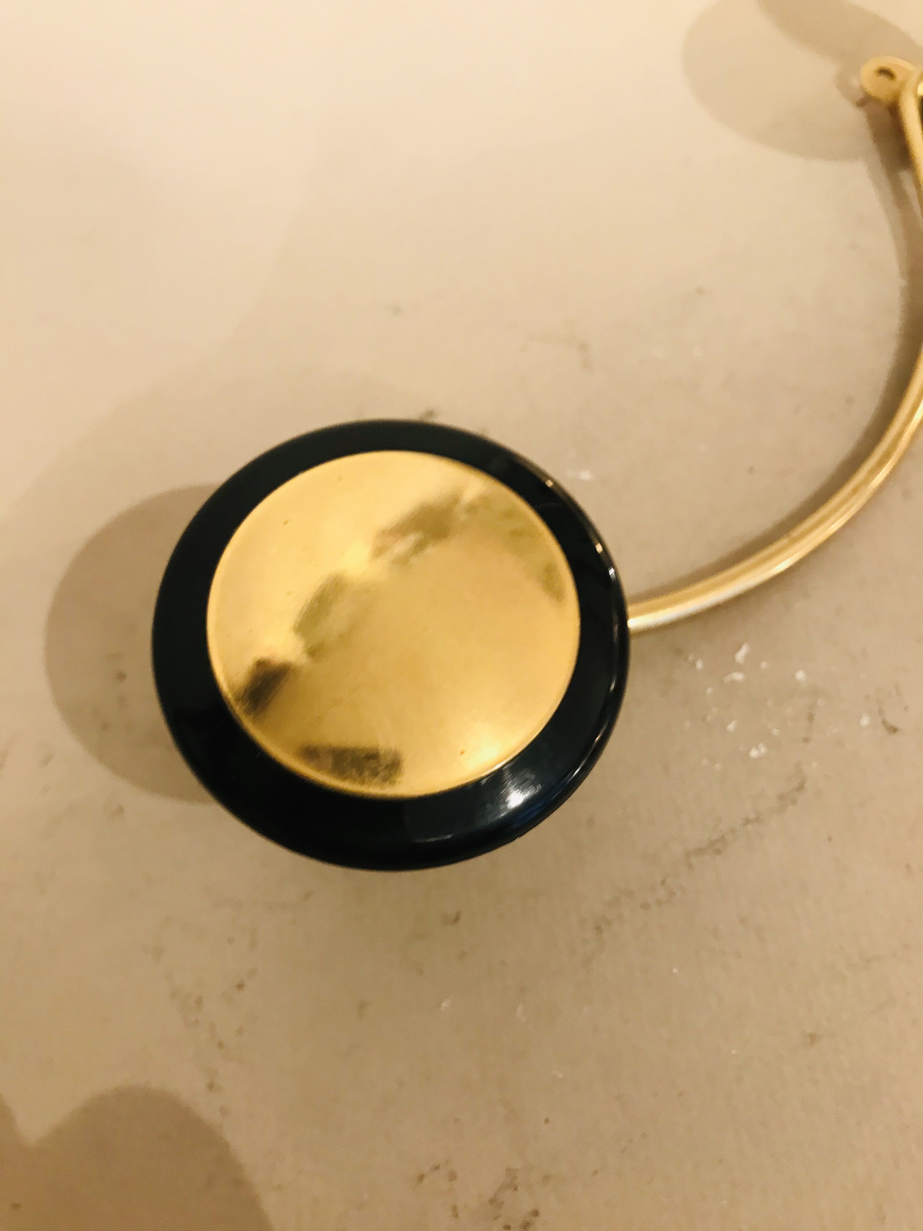 Gold and black metal coatrack 1960