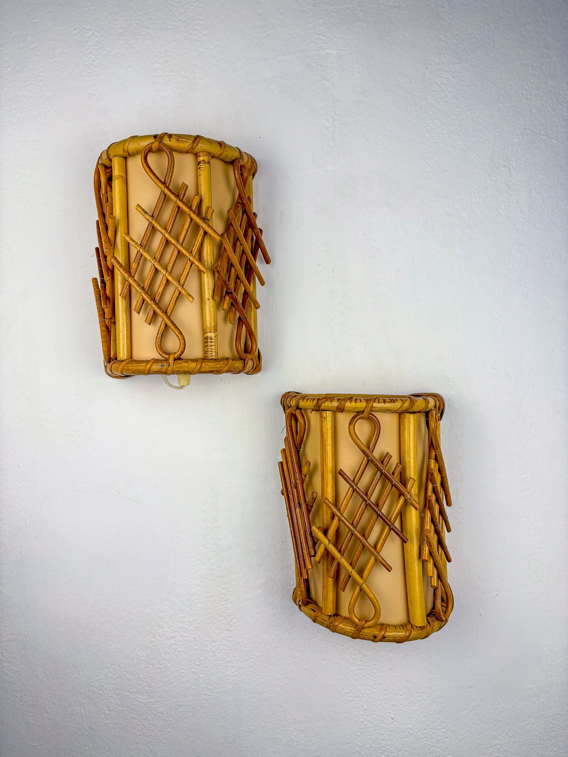 Pair of mid-century rattan wall sconces, circa 1970s, Italy