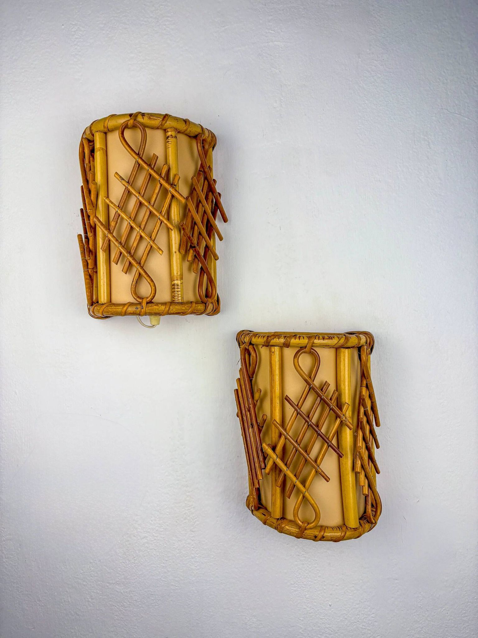 Pair of mid-century rattan wall sconces, circa 1970s, Italy