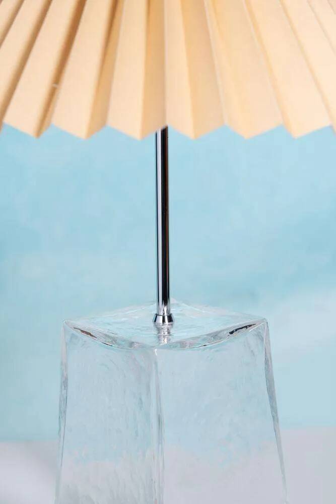 Minimalist glass table lamp from the 80s with a pleated shade.