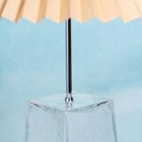 Minimalist glass table lamp from the 80s with a pleated shade.