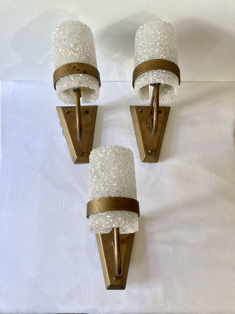 Set of three wall sconces in gold metal and ice effect Perspex, 1960-70.