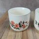 Set of 3 vintage ceramic cups with floral decoration.