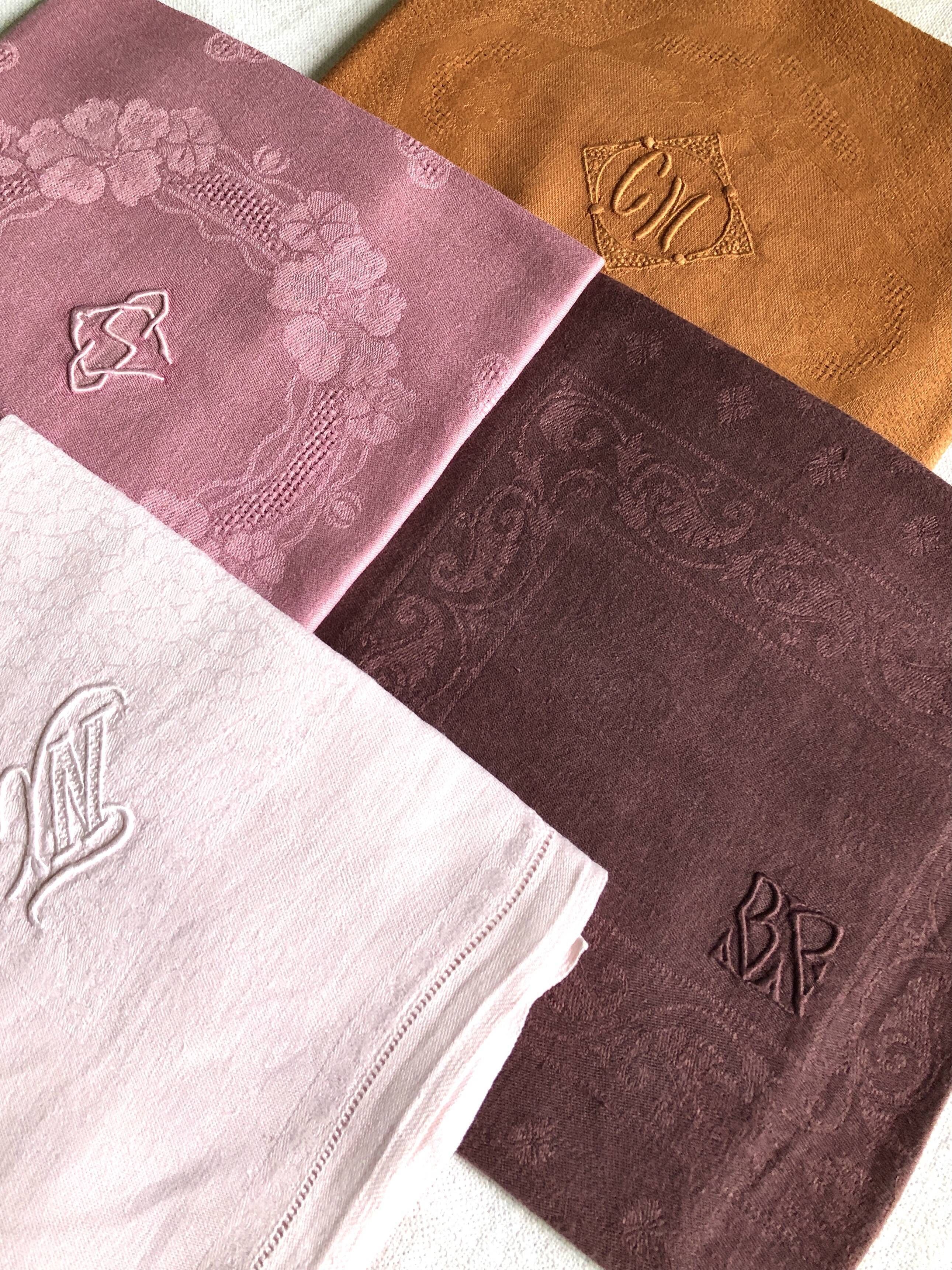 Set of four old damask towels tinted in multiple colors