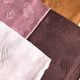 Set of four old damask towels tinted in multiple colors