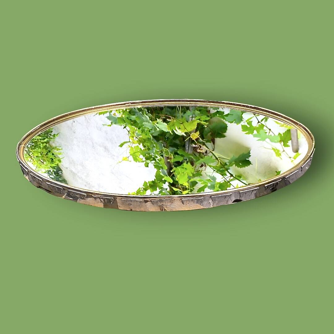 Large antique oval wall mirror in stylized gilt metal, – Hollywood Regency