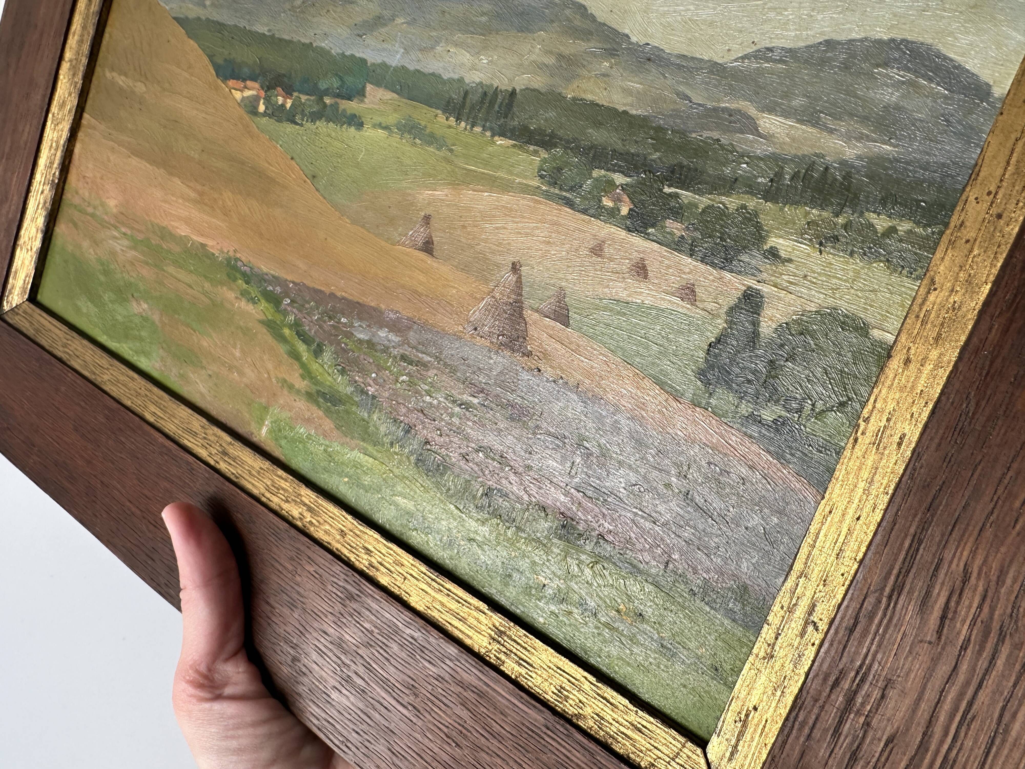 Old oil painting of a landscape on panel from 1920, haystacks.