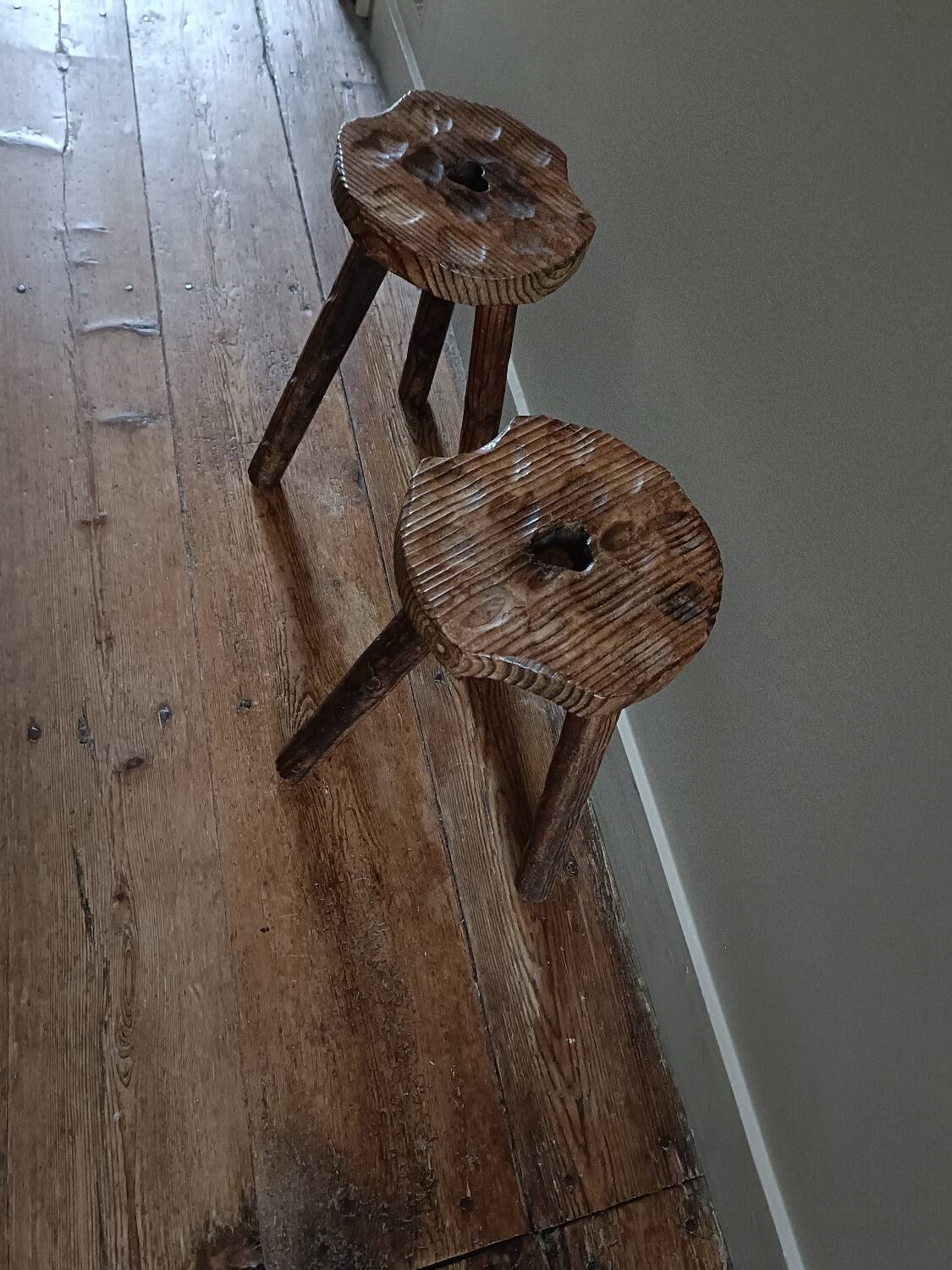 A pair of tripod stools