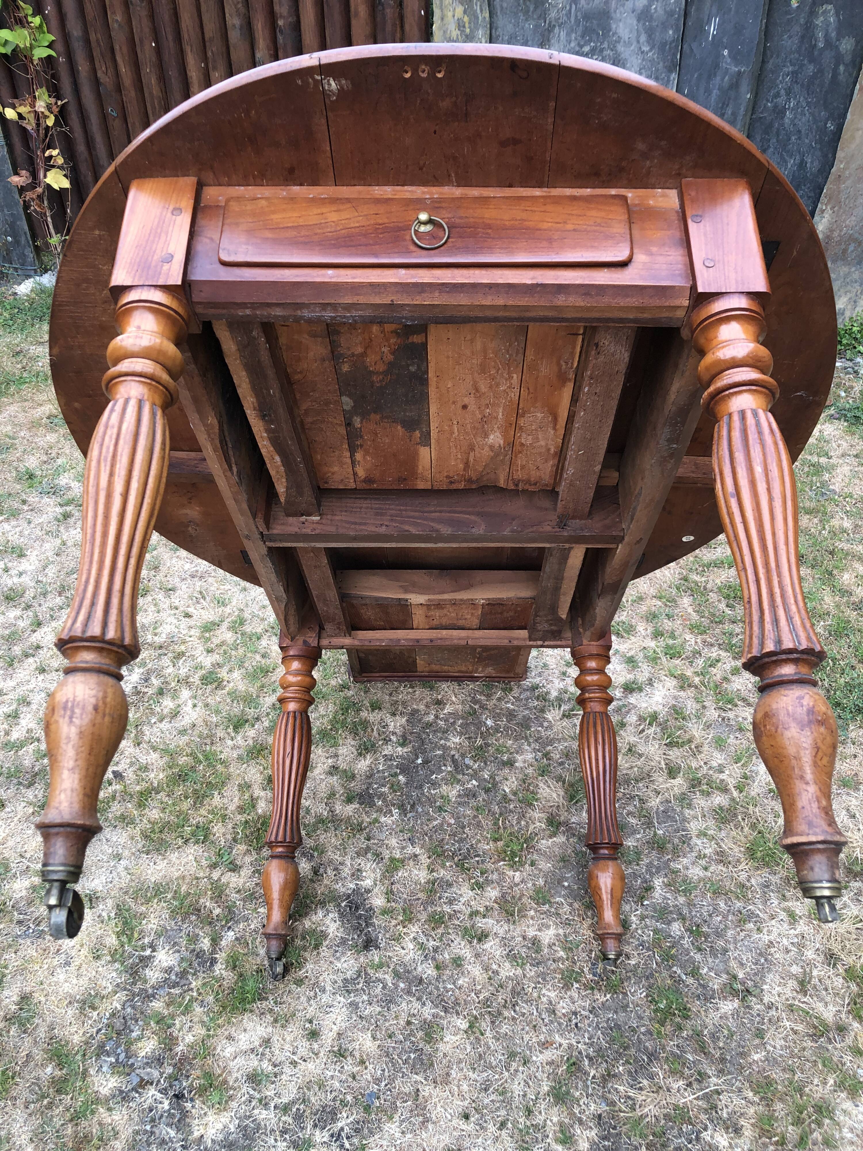 Louis Philippe oval drop-leaf table in solid cherry wood with 2 drawers.