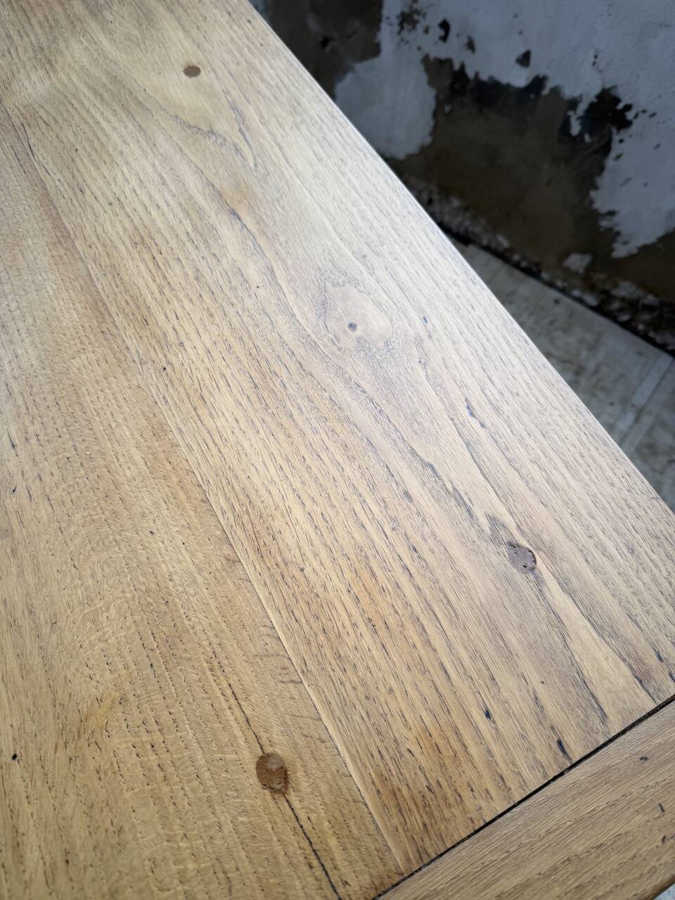 Oak farmhouse table with turned black legs.