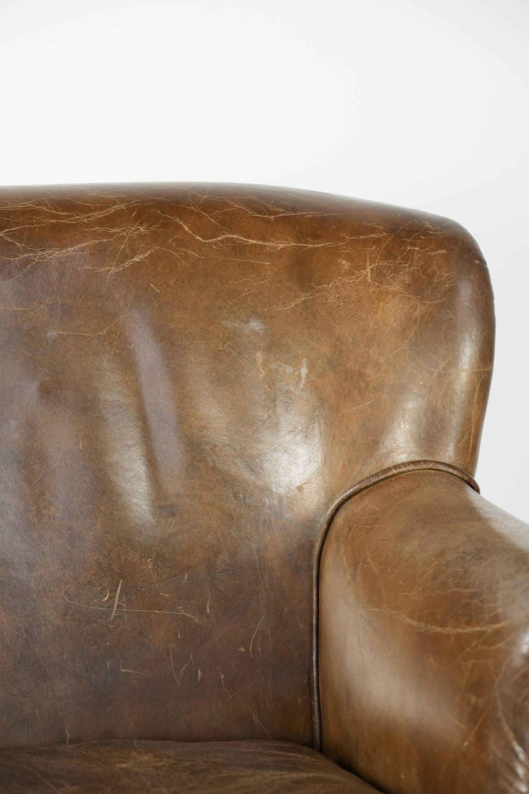 Robust cowhide armchair in a beautifully subtle size with a wonderful patina.