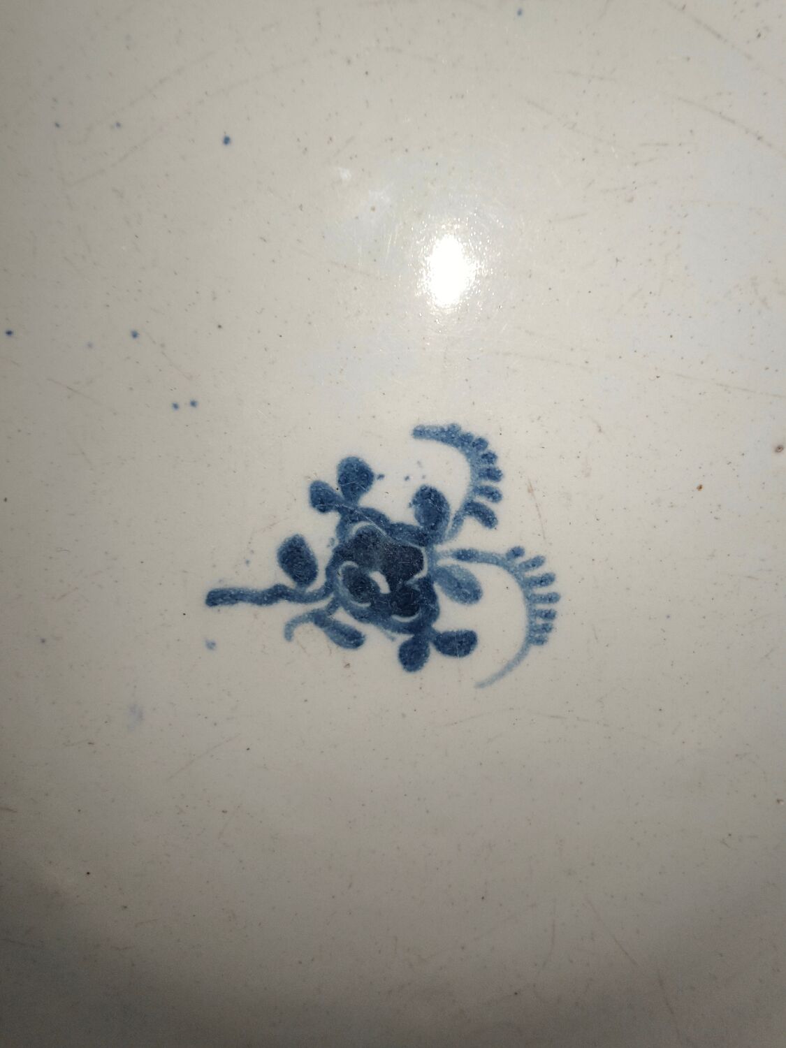 Old plate in Northern earthenware with blue floral decoration eighteenth century