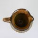 Glazed ceramic jug with plant decoration