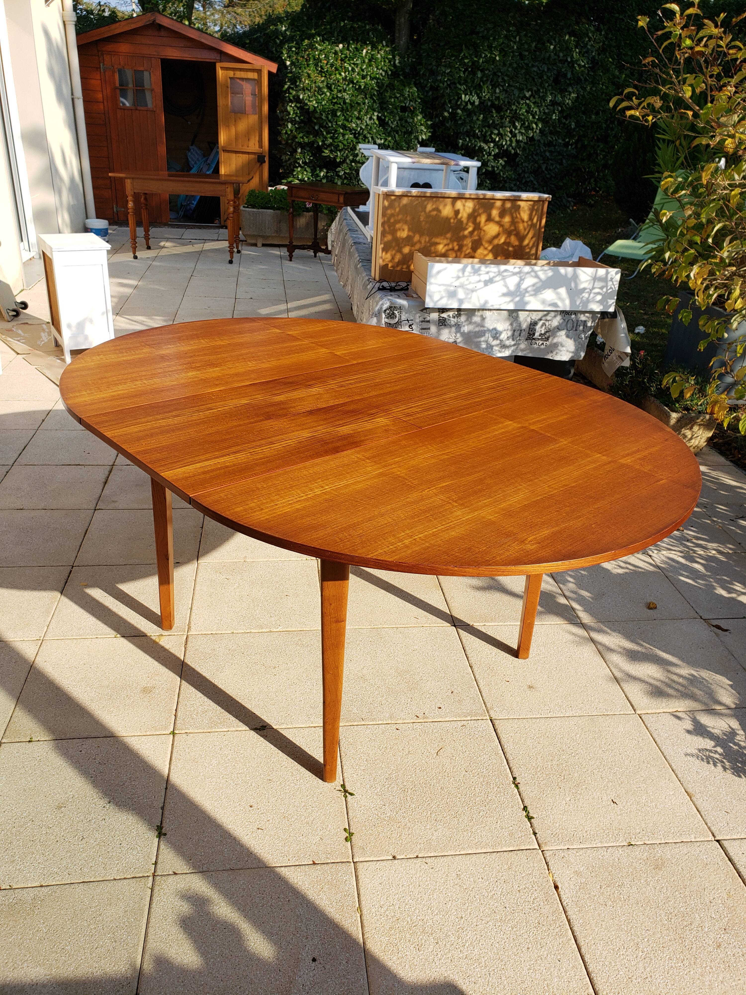 Round extendable teak dining table from the 60s
