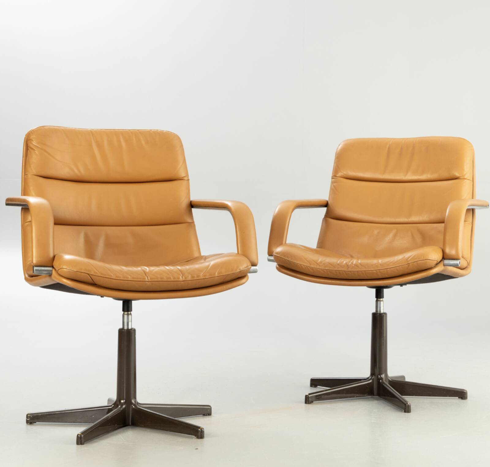 Pair of swivel armchairs by Geoffrey Harcourt.