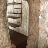 Vintage 1960 free-form mirror known as a retro mirror with a gold and black metal trim.