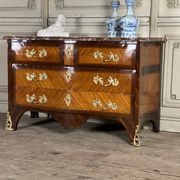 Louis XV style commode in rosewood and palisander veneer, gilt bronze mounts, and Rance marble top.
