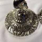 Two silver-plated metal candlesticks decorated with cherubs, 20th century