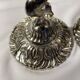 Two silver-plated metal candlesticks decorated with cherubs, 20th century