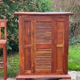 Exotic wood bar with 2 high stools.