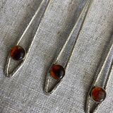 Art Nouveau metal and amber spoons