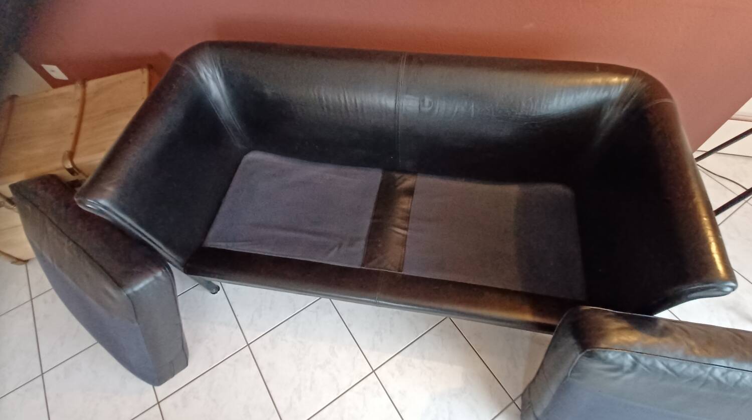 Black leather two-seater sofa