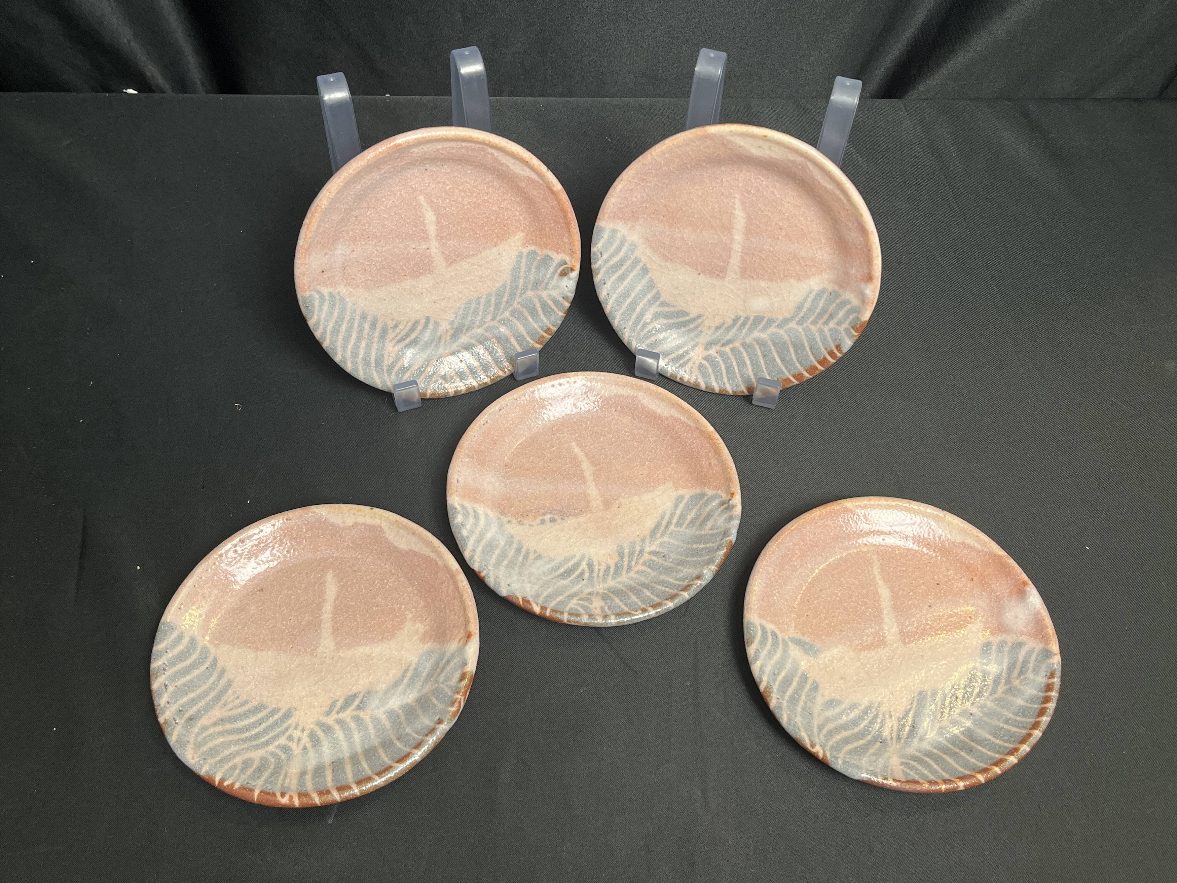 Set of five small Korean stoneware plates with pink crane, 20th century