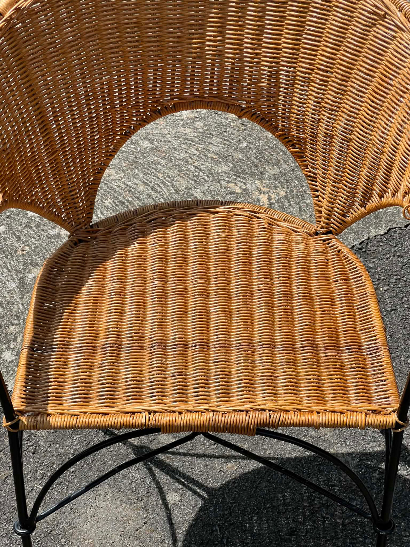 Wicker and black wrought iron armchair